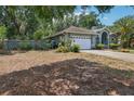Charming one-story home featuring an attached garage and lush landscaping at 1254 Magnolia Farms Ct, Eustis, FL 32726