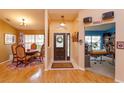 Bright entryway with wood floors, decorative lighting, and a view into the dining area at 12846 Brown Bark Trl, Clermont, FL 34711