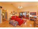 Cozy living room with vaulted ceilings, warm paint, and bright wood floors at 12846 Brown Bark Trl, Clermont, FL 34711