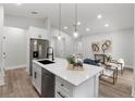 Kitchen with a view into the living room, featuring white cabinets and stainless steel appliances at 13524 Sw 89 St, Dunnellon, FL 34432