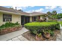 Charming single-story home featuring lush landscaping and a welcoming entrance at 1512 S Pointe Dr, Leesburg, FL 34748