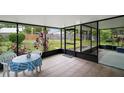 This screened patio features tile floors, a ceiling, and outdoor views at 1512 S Pointe Dr, Leesburg, FL 34748
