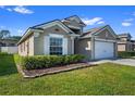 Charming single-story home featuring a well-manicured lawn and an attached two-car garage at 15501 Markham Dr, Clermont, FL 34714