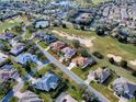 Stunning aerial view of home with golf course view, tennis courts and landscaping at 1573 Blenheim Trl, The Villages, FL 32162