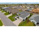 Overhead shot of home in quiet neighborhood with well manicured lawns at 2170 Biller Cir, The Villages, FL 32163