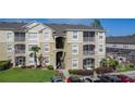 Modern condo building with well-maintained landscaping, visible balconies, and convenient parking at 2310 Silver Palm Dr # 301, Kissimmee, FL 34747