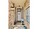 Covered front porch with brick accents, decorative elements, and a welcoming entrance at 3051 Newmark Dr, Deltona, FL 32738