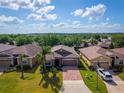 Aerial view of a home in a residential area, showcasing the brick driveway and well-kept landscaping at 3654 Limestone St, Clermont, FL 34711