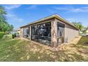 A screened-in patio area, perfect for outdoor relaxation, overlooks the lush backyard at 3654 Limestone St, Clermont, FL 34711