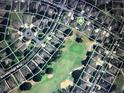 Neighborhood aerial view features golf course, mature trees, and neatly arranged homes at 3708 Fairfield Dr, Clermont, FL 34711