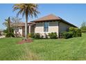 Well-maintained lawn and landscaping surrounding a neutral home, complemented by a clear, sunny sky at 39505 Hillrise Ln, Lady Lake, FL 32159