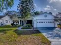 Charming home boasts a well-manicured lawn, mature landscaping, and an attached two-car garage at 507 Torres Pl, The Villages, FL 32159