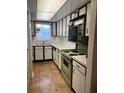 Cozy kitchen featuring a vintage stove and ample cabinet space at 601 N Mcdonald St # 408, Mount Dora, FL 32757