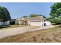 Attractive home with a spacious driveway, well-maintained lawn, and attached two-car garage at 605 Westview Dr, Minneola, FL 34715