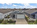 Aerial view showcasing the property's well-maintained landscaping, two-car garage and screened in porch at 6248 Siverson Ter, The Villages, FL 32163
