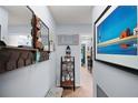 Inviting entryway featuring coat rack, decorative shelf, bench and coastal-themed artwork at 638 Mount Homer Rd # 3-C, Eustis, FL 32726