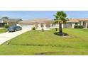Charming single-story home with well-maintained lawn, garden, and a beautiful palm tree at 685 Reindeer Dr, Kissimmee, FL 34759