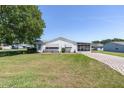 Charming home features a well-maintained lawn, and screened in porch, creating an inviting curb appeal at 705 Prado Dr, The Villages, FL 32159