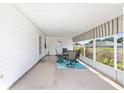 Covered patio with neutral furniture set on a decorative area rug, offering a perfect outdoor space at 705 Prado Dr, The Villages, FL 32159