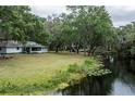 Expansive backyard featuring lush greenery extending to the waterway, perfect for outdoor activities and relaxation at 7938 Jacksons River Rd, Leesburg, FL 34788