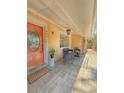 Cozy front porch with stylish seating, textured walls, and a bright front door at 802 Haselton St, Eustis, FL 32726