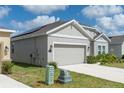 Side view of a well-maintained house showcasing an attached garage and lush green lawn at 853 Laurel View Way, Groveland, FL 34736