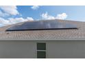 Roof with modern solar panels, providing energy efficiency to this home at 853 Laurel View Way, Groveland, FL 34736