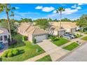 Aerial view showcases a well-kept neighborhood with manicured lawns and similar single-story homes at 9081 Saint Andrews Way, Mount Dora, FL 32757