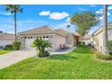 Lovely single-story home with a lush lawn, stone details, and outdoor seating on a sunny day at 9081 Saint Andrews Way, Mount Dora, FL 32757