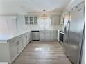 Bright kitchen with stainless steel appliances, quartz countertops, and modern cabinetry at 997 Oscar Ln, The Villages, FL 32162
