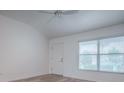 Bright bedroom with white walls, lots of natural light, and wood-look flooring at 1346 Kilgore Way, The Villages, FL 32163