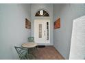 Inviting entryway featuring a mosaic table and charming decor at 10021 Lake Miona Way, Oxford, FL 34484