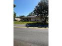 One-story house featuring solar panels and a green front yard at 10517 52Nd Ct, Belleview, FL 34420