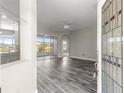 Welcoming view of the living area with gray wood-look floors and access to a sliding door to the lanai at 11780 Se 178Th St, Summerfield, FL 34491