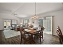 Spacious living and dining area featuring wood floors and sliding doors leading to the patio at 1251 Saranac Pl, The Villages, FL 32163