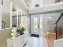 Bright foyer with white tile flooring, staircase, and stylish decor at 13519 Bristlecone Cir, Orlando, FL 32828