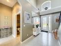 Inviting foyer with a view to a half bathroom and a decorative front door at 13519 Bristlecone Cir, Orlando, FL 32828