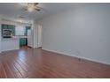 Living room with tile floors open to the kitchen and nearby doorway at 1400 Eudora Rd # A08, Mount Dora, FL 32757