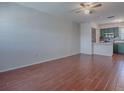 Open-concept living room and kitchen with wood-look tile floors and a ceiling fan at 1400 Eudora Rd # A08, Mount Dora, FL 32757