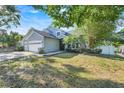 Charming two-story home featuring an arched entry and lush, mature landscaping at 14305 Pine Cone Trl, Clermont, FL 34711