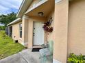 Close up on an inviting front entrance with decorative floral arrangement at 156 Ridgebrook Ct, Davenport, FL 33896