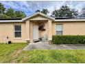 Inviting front porch with decorative plants and seating, perfect for relaxation at 156 Ridgebrook Ct, Davenport, FL 33896