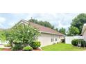 Well manicured backyard featuring bright green lawn and mature shade trees at 15702 Bay Vista Dr, Clermont, FL 34714