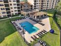 Community pool with many lounge chairs and covered seating area at 16300 County Road 455 # 511, Montverde, FL 34756