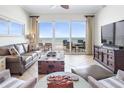 Bright living room with sliding glass doors leading to a balcony overlooking the ocean at 1705 S Atlantic Ave # 502, New Smyrna Beach, FL 32169