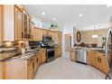 The updated kitchen is equipped with stainless steel appliances and granite countertops at 1716 Bugle Ter, The Villages, FL 32162