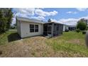 Backyard featuring a screened lanai at 17930 Se 83Rd Melody Ave, The Villages, FL 32162