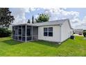 View of the home's exterior featuring a screened lanai perfect for outdoor living and relaxing at 17930 Se 83Rd Melody Ave, The Villages, FL 32162