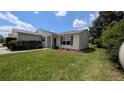Well-kept single-story home featuring a tidy lawn and tasteful landscaping at 17930 Se 83Rd Melody Ave, The Villages, FL 32162