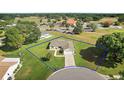 Aerial view of a beautiful home in a well-maintained community with lush landscaping at 17985 Se 102Nd Ct, Summerfield, FL 34491